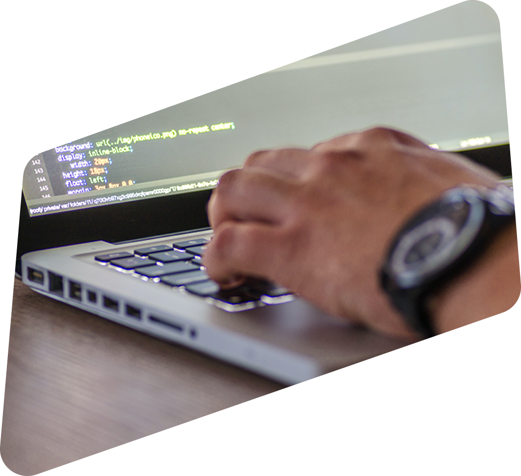 Close-up of a software developer writing code at a computer at a software development company